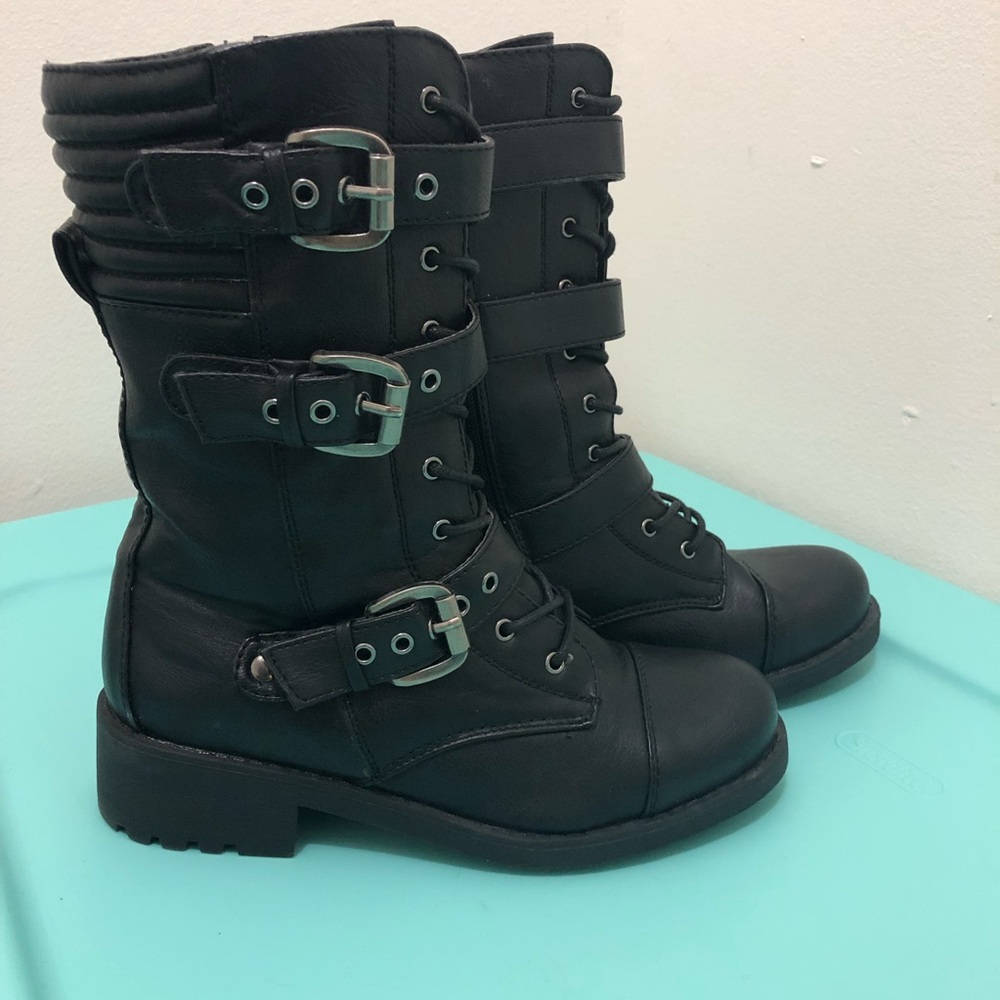Black combat boots with straps and buckles